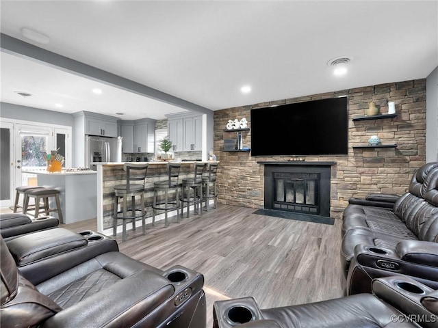 living room featuring a fireplace and light wood-type flooring