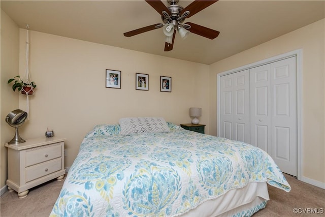 carpeted bedroom featuring ceiling fan and a closet