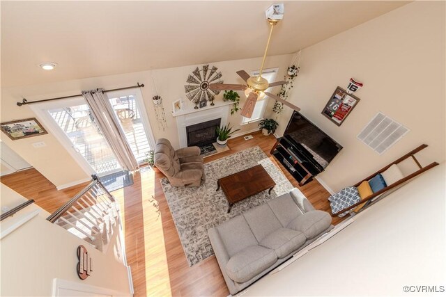 living room with ceiling fan and light hardwood / wood-style floors