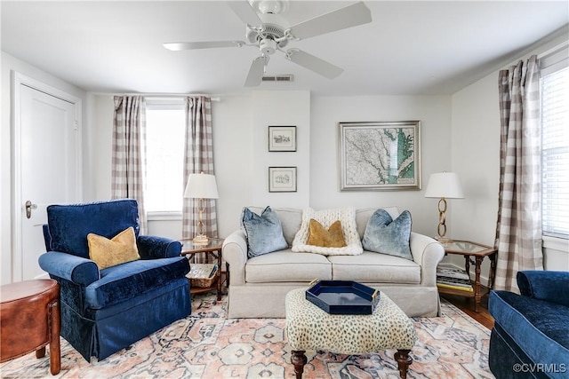 living room featuring light hardwood / wood-style floors and ceiling fan