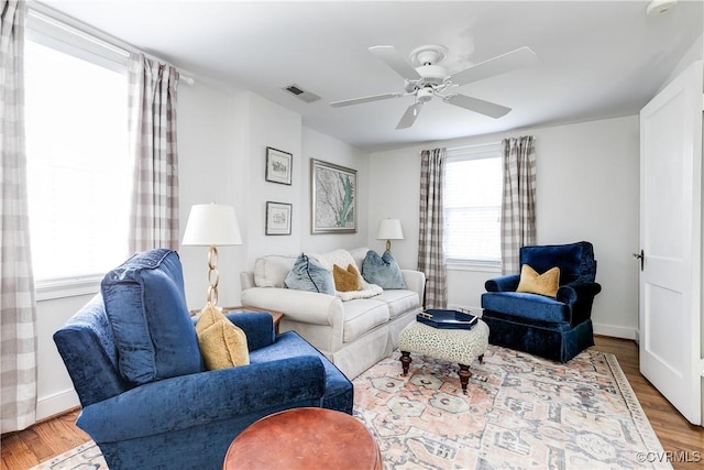 living room with ceiling fan and wood-type flooring