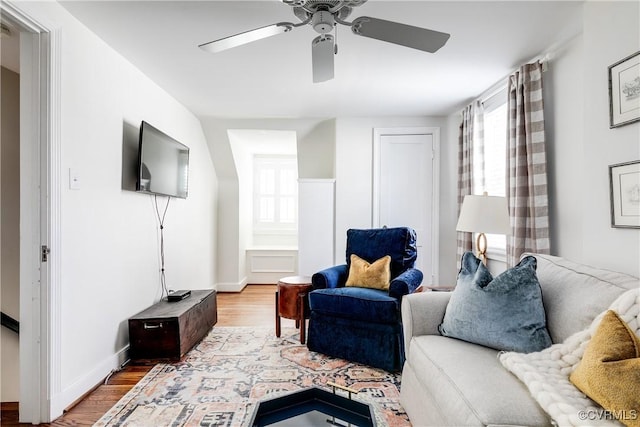 living room featuring hardwood / wood-style flooring and ceiling fan