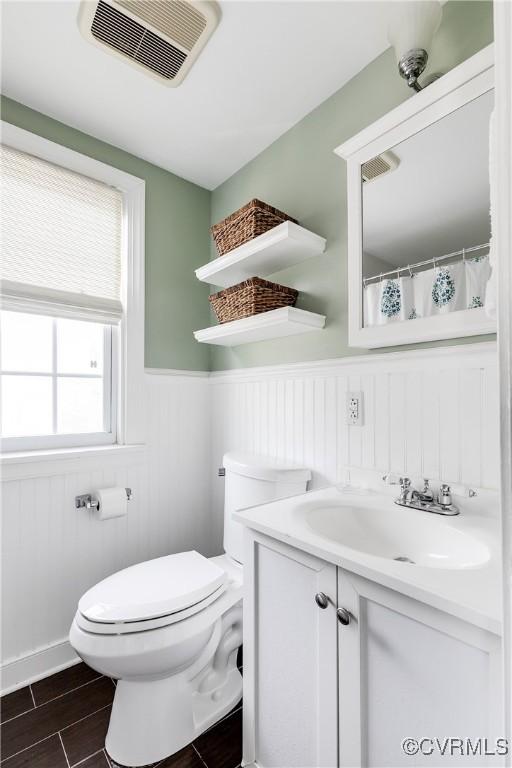 bathroom featuring vanity and toilet