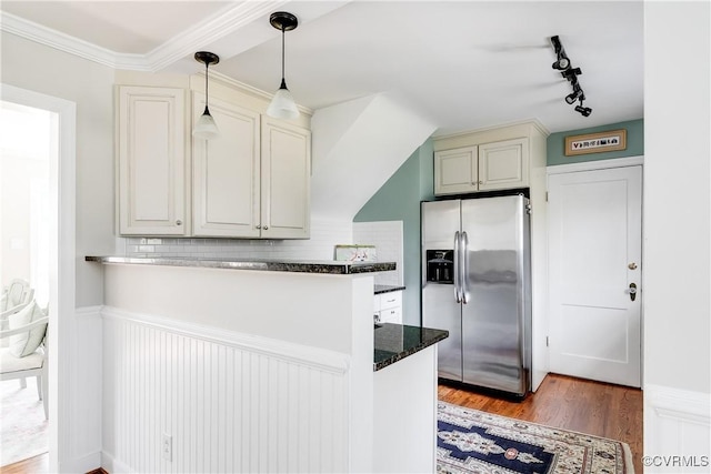 kitchen featuring tasteful backsplash, dark hardwood / wood-style flooring, stainless steel fridge with ice dispenser, decorative light fixtures, and kitchen peninsula