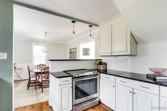 kitchen featuring stainless steel range with electric stovetop, pendant lighting, ornamental molding, and light hardwood / wood-style floors