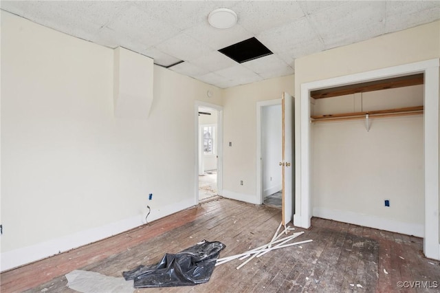 unfurnished bedroom featuring dark hardwood / wood-style flooring and a closet