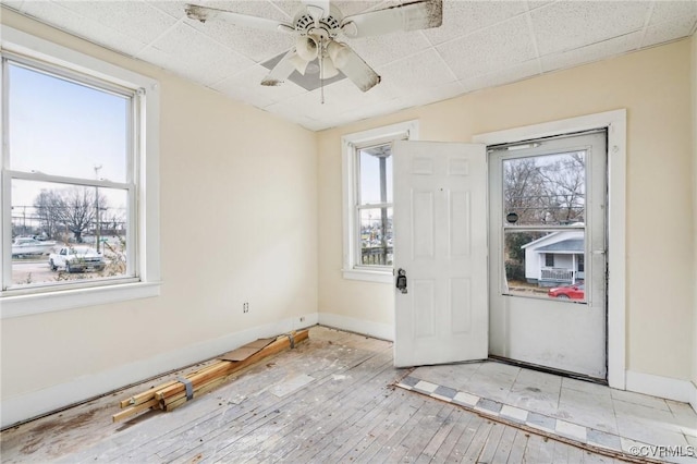 unfurnished room with ceiling fan, plenty of natural light, and light wood-type flooring