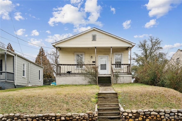 bungalow-style house featuring a front lawn and a porch