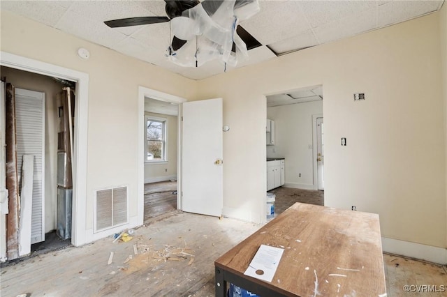 unfurnished bedroom featuring ceiling fan and ensuite bathroom