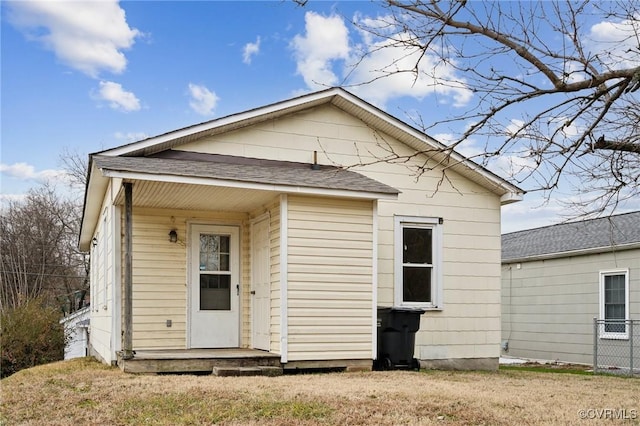 rear view of house featuring a yard