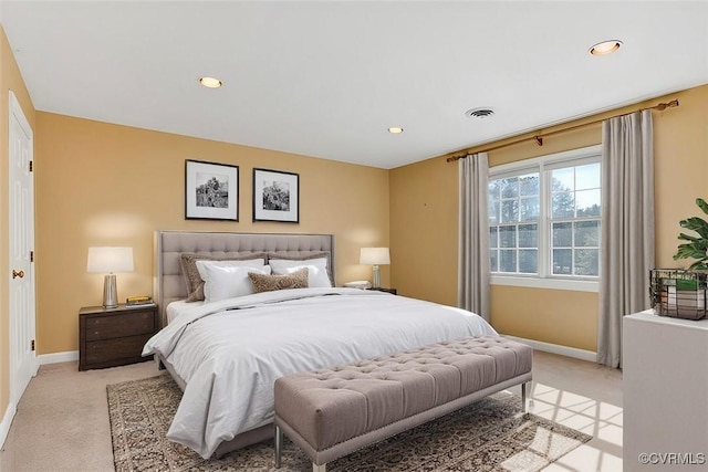 bedroom with light carpet, recessed lighting, visible vents, and baseboards