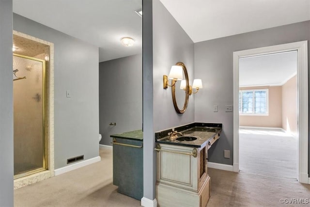 bathroom with a stall shower, visible vents, baseboards, and vanity