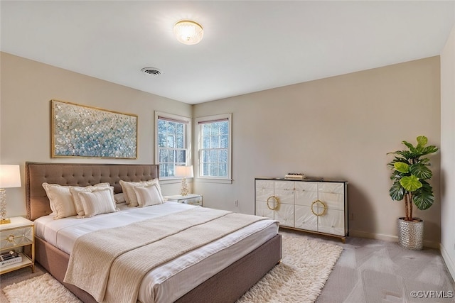 bedroom featuring light colored carpet, visible vents, and baseboards