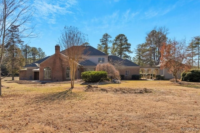 view of property exterior with a lawn and a chimney