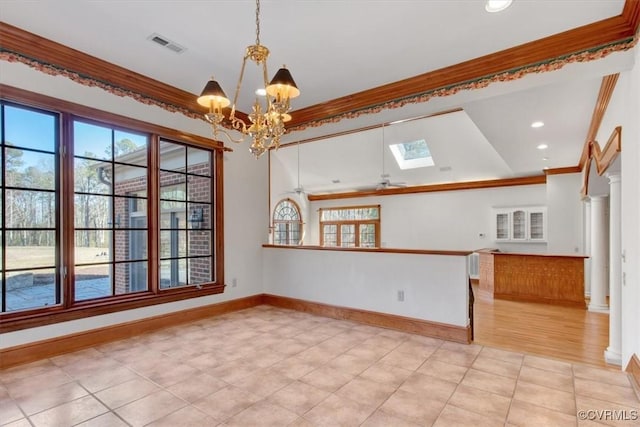 spare room with a healthy amount of sunlight, a skylight, and crown molding