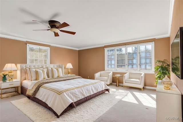 bedroom with light carpet, a ceiling fan, baseboards, and crown molding