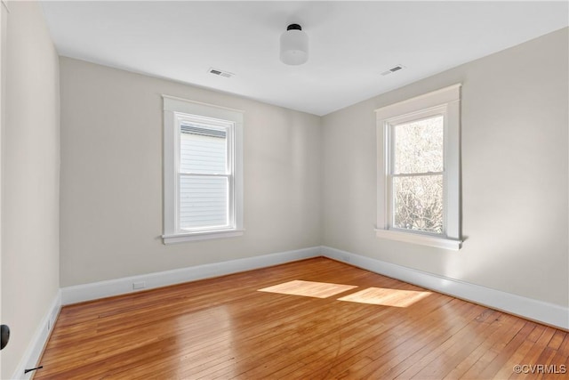 unfurnished room featuring hardwood / wood-style flooring