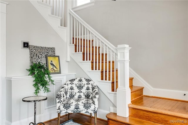 staircase with wood-type flooring