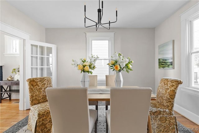 dining space featuring a notable chandelier and wood-type flooring