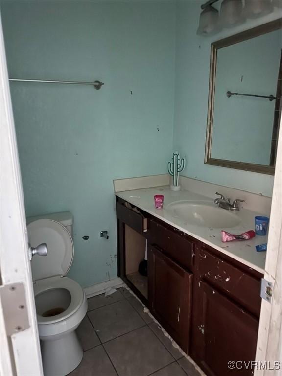 bathroom featuring tile patterned floors, toilet, and vanity