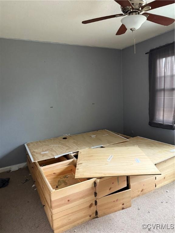 unfurnished bedroom featuring carpet floors and ceiling fan