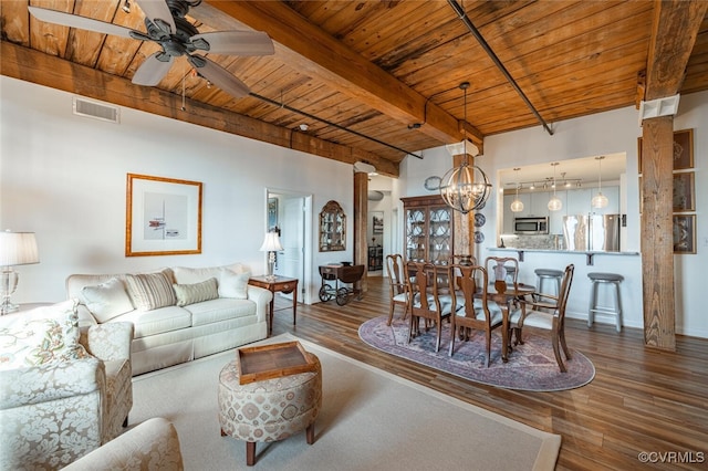 living room featuring hardwood / wood-style flooring, ceiling fan with notable chandelier, decorative columns, and wooden ceiling