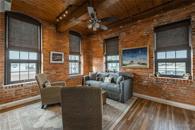 living room featuring brick wall, a healthy amount of sunlight, hardwood / wood-style floors, and wood ceiling