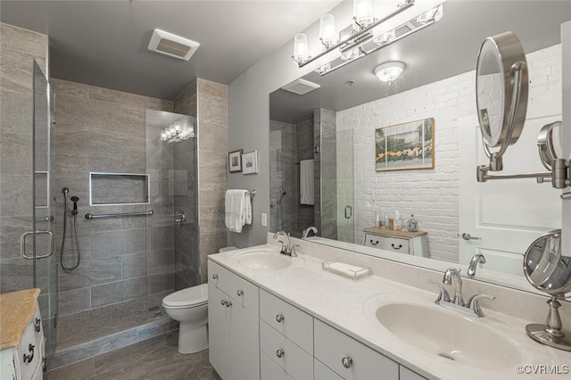 bathroom featuring vanity, an enclosed shower, and toilet