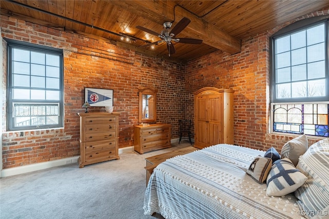 bedroom with wood ceiling, beamed ceiling, ceiling fan, brick wall, and carpet