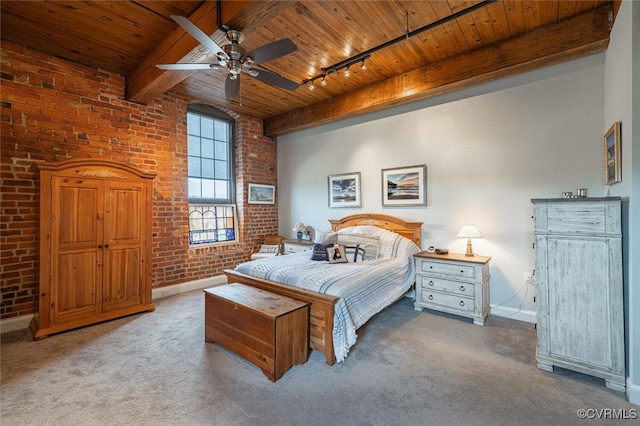 bedroom featuring wood ceiling and brick wall