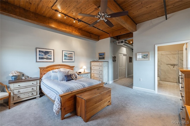 bedroom with ensuite bath, rail lighting, light colored carpet, wood ceiling, and beam ceiling