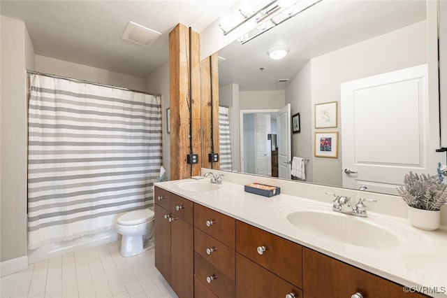 bathroom with vanity, curtained shower, tile patterned floors, and toilet