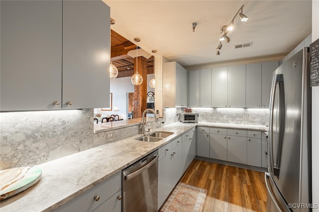 kitchen with gray cabinets, appliances with stainless steel finishes, and sink