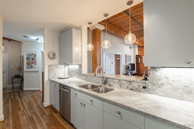 kitchen featuring pendant lighting, sink, decorative backsplash, stainless steel dishwasher, and light stone countertops