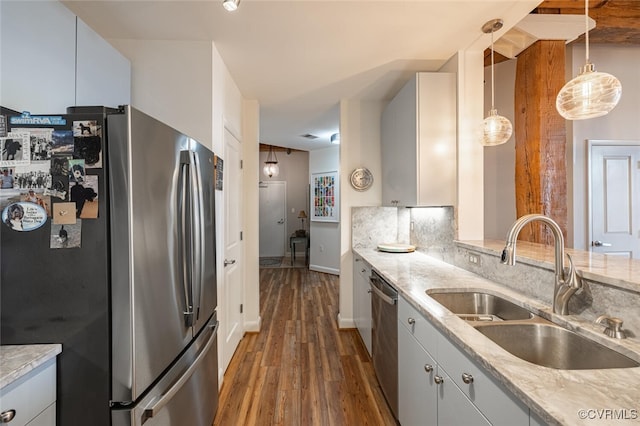 kitchen featuring sink, white cabinetry, pendant lighting, stainless steel appliances, and light stone countertops