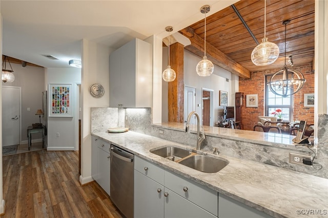 kitchen featuring sink, dishwasher, light stone counters, white cabinets, and brick wall