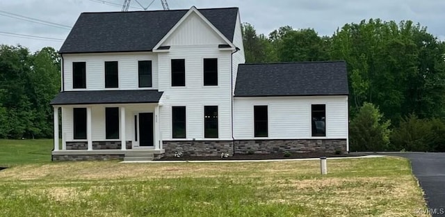 view of front facade with covered porch and a front lawn