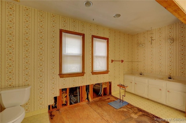 bathroom featuring tile patterned flooring, vanity, and toilet