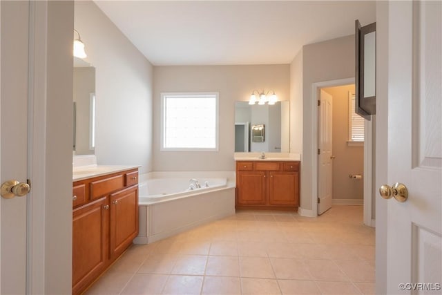 bathroom featuring vanity, a bathtub, and tile patterned floors