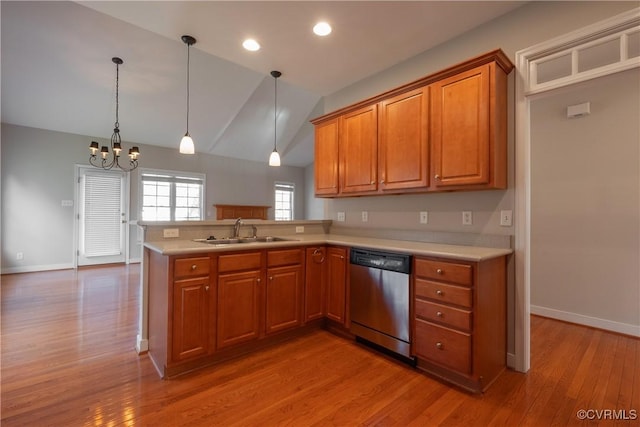 kitchen with sink, light hardwood / wood-style floors, decorative light fixtures, stainless steel dishwasher, and kitchen peninsula