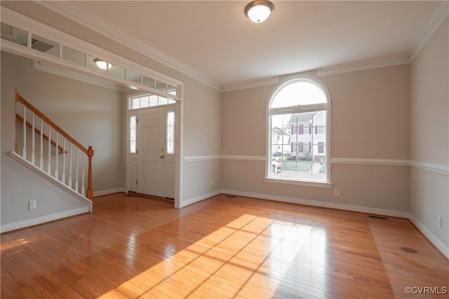 entryway featuring ornamental molding and light wood-type flooring