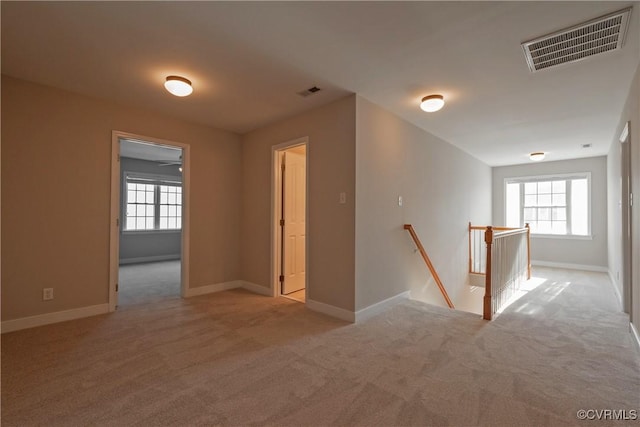 unfurnished room with light colored carpet