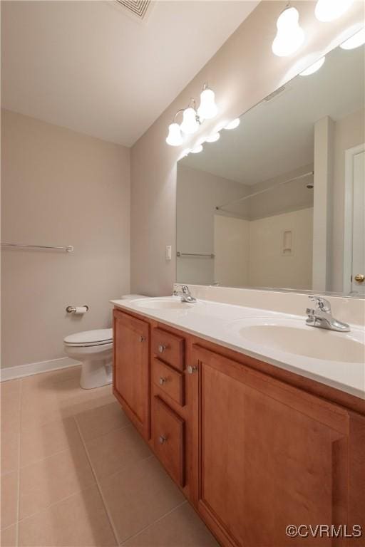 bathroom featuring vanity, tile patterned floors, and toilet