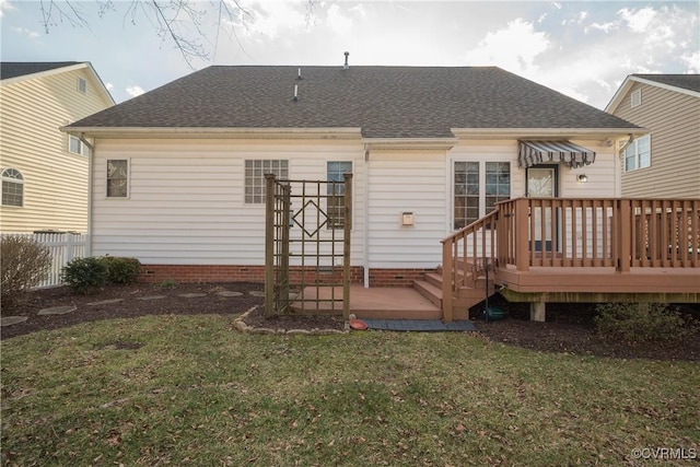 rear view of house featuring a yard and a deck