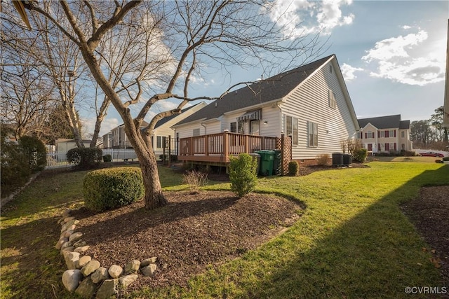 exterior space featuring cooling unit, a deck, and a lawn