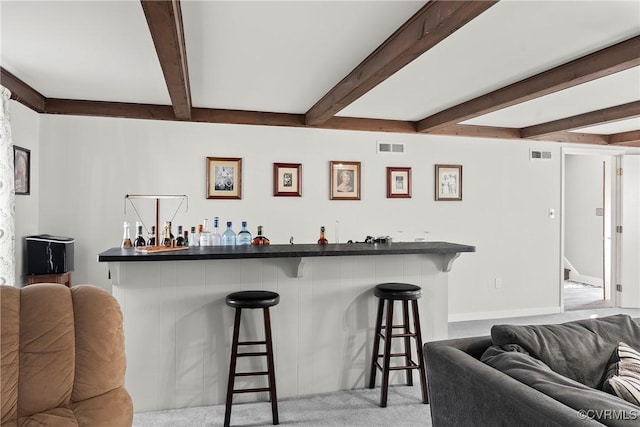 bar with light carpet and beamed ceiling