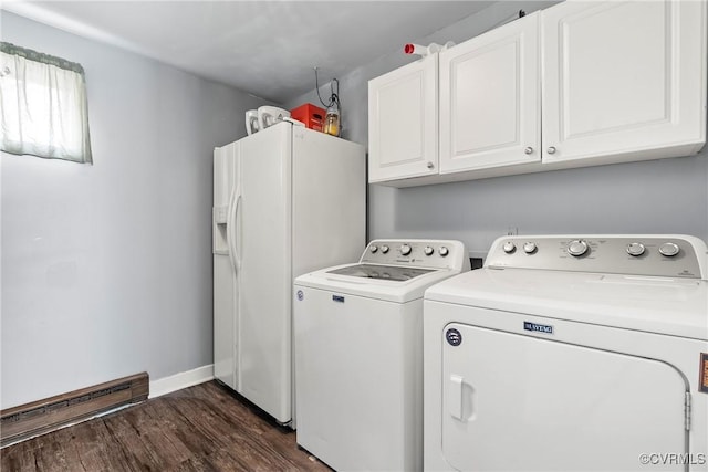 laundry room with dark hardwood / wood-style flooring, a baseboard radiator, cabinets, and washing machine and clothes dryer