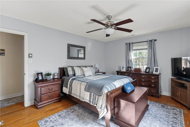 bedroom with ceiling fan and light hardwood / wood-style flooring