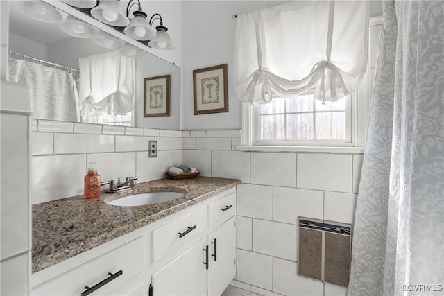 bathroom featuring tile walls and vanity