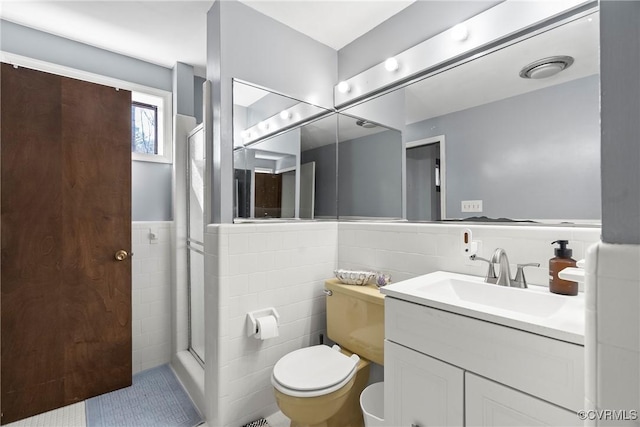 bathroom featuring vanity, tile walls, an enclosed shower, and toilet